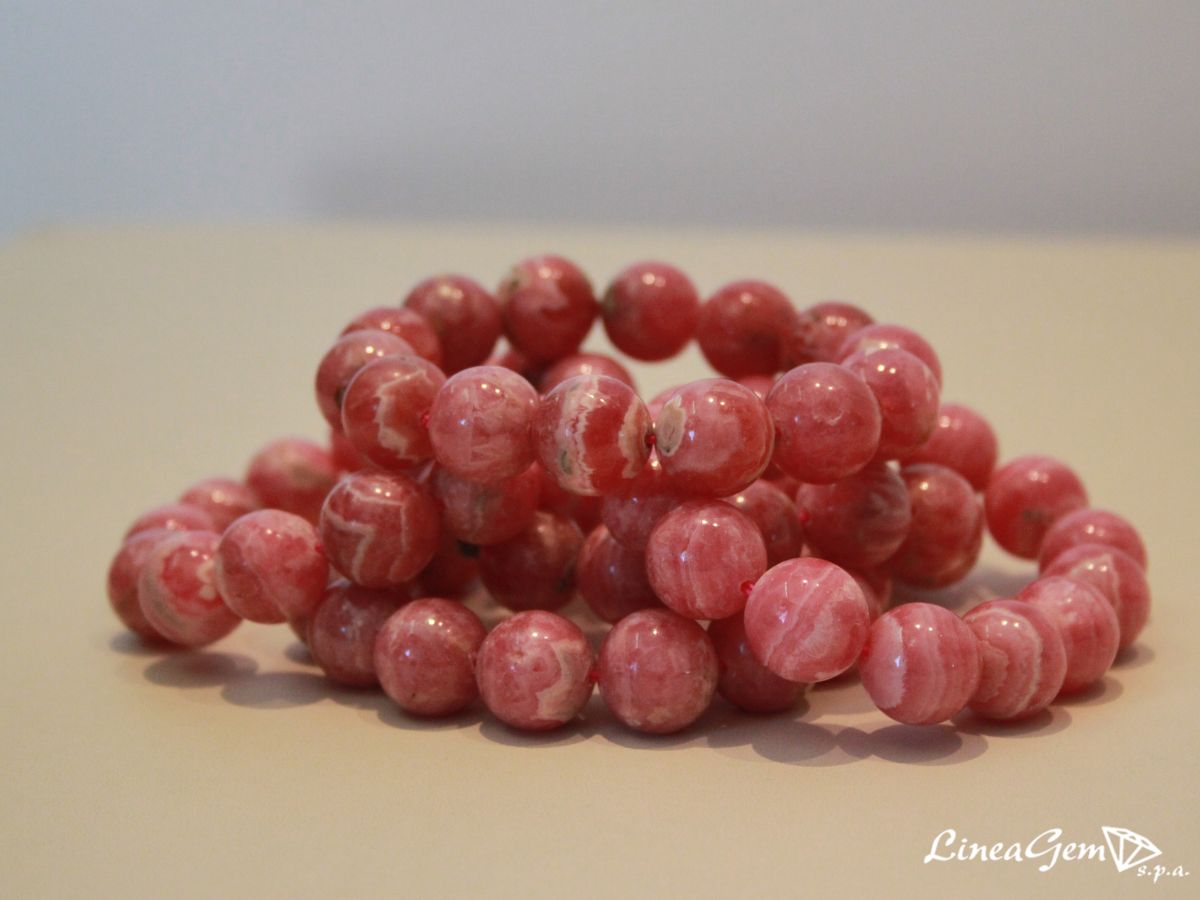 Bracelets in natural spherical smooth rhodochrosite.